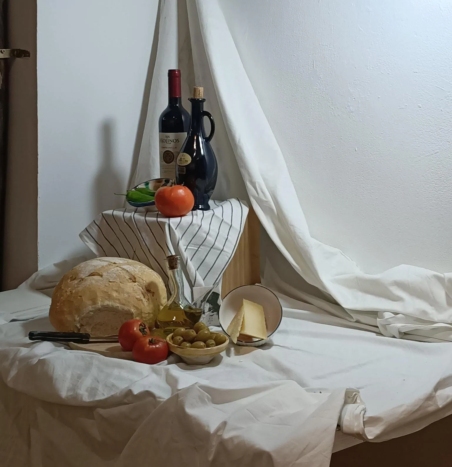 Bodegón montado en el estudio con pan, fruta y botellas