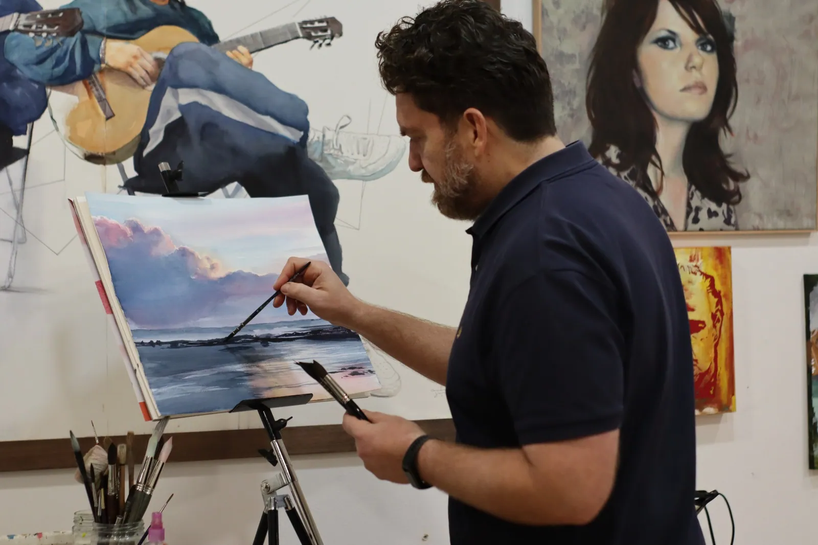 Emmanuel Luna pintando una marina en acuarela ante el caballete